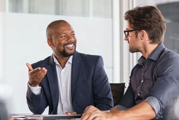 Our Business Partners - Two Businessmen Working Together on a Project in the Office